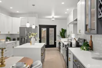 Charming French doors create seamless access to the backyard for grilling and gatherings, while a spacious walk-in pantry sits conveniently to the left