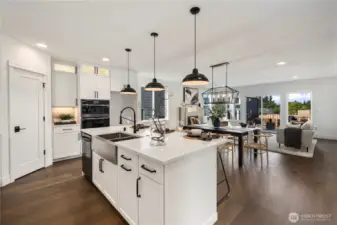 Kitchen to Great Room: The open-concept kitchen flows into the dining and living areas, enhanced by oversized windows that draw in natural light. Entertain with ease as conversations move seamlessly from meal prep to gatherings around the table or by the fireplace.  These photos are of the actual, staged home being sold at Foxmoore. However, all photos, renderings, site maps, and floorplans are for visualization purposes only. Plans, colors, building orientation, finishes, home outlook, and other details can and WILL vary.