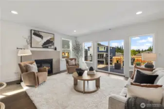 Great Room with Fireplace: Anchored by a sleek tile-surround gas fireplace, the great room offers comfort and style in equal measure. Oversized windows frame neighborhood views, while the open design makes this a natural hub for daily living.  These photos are of the actual, staged home being sold at Foxmoore. However, all photos, renderings, site maps, and floorplans are for visualization purposes only. Plans, colors, building orientation, finishes, home outlook, and other details can and WILL vary.