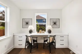 Main Level Pocket Office Nook: Built-in desk with dual workspaces and drawers sits perfectly by bright windows, offering a quiet spot for productivity or creativity. Its central location keeps it connected to the main living areas while maintaining a sense of retreat.  These photos are of the actual, staged home being sold at Foxmoore. However, all photos, renderings, site maps, and floorplans are for visualization purposes only. Plans, colors, building orientation, finishes, home outlook, and other details can and WILL vary.