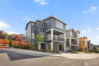 Exterior: Modern three-story design with clean lines, covered balcony, and two-car garage. Situated within the Foxmoore community, blending style and functionality. These photos are of the actual, staged home being sold at Foxmoore. However, all photos, renderings, site maps, and floorplans are for visualization purposes only. Plans, colors, building orientation, finishes, home outlook, and other details can and WILL vary.