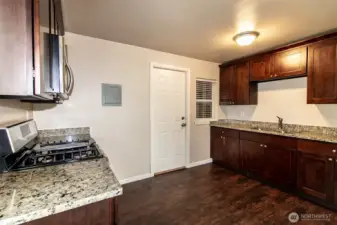 Kitchen in Unit B - door leads to utility room and rear access
