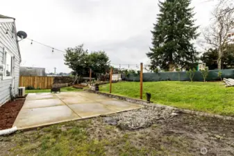 Generous patio space with firepit and lighting