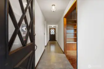 Main entry with access to a large deck and view of the front of the property.