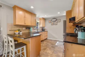 Updated maple cabinets in kitchen with Whirlpool appliances.