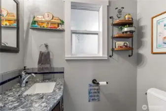 Half bath conveniently located off garage/pantry/laundry area.