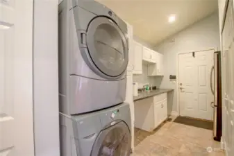 Laundry room with sink, second refrigerator and storage.