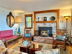 Sitting room with fireplace is open to the dining area and kitchen with access to the wraparound deck.