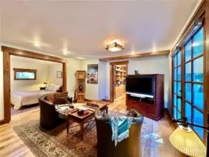 Sitting room with fireplace is open to the dining area and kitchen with access to the wraparound deck.