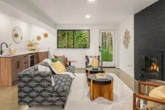 Lower level den/bonus room with polished concrete flooring, separate entrance, and custom wet bar