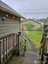 Back porch leading to garage, gazebo & shed