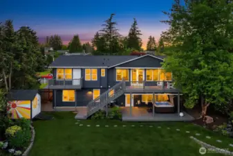 Quintensential wide level spacious lot with two decks , two patios, vegetable garden, hot tub and pizza oven.