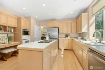 Large kitchen offers a walk in pantry, breakfast bar, large windows and access to back deck.