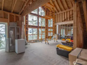 The great room with 24' floor to ceiling windows.