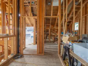 Standing in the loft, looking at the bonus room upstairs with a detached bathroom to the left featuring a jetted tub.