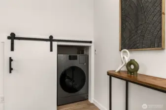 Tidy and tucked away—your laundry station hides behind a stylish barn door for sleek utility.