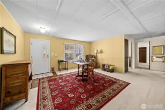 Spacious living room filled with natural light, offering plenty of space to gather with friends or unwind at the end of the day.