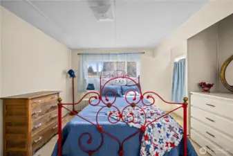 Generous primary suite with views of the backyard, offering a peaceful retreat and easy access to the private bath.