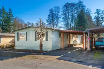 Side exterior showcasing covered parking and easy access to the home.