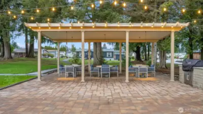 Covered pavilion with café lighting offers the perfect setting for BBQs, celebrations, and evening socials.