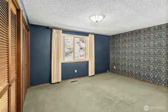 A spacious primary bedroom to unwind at the end of the day.