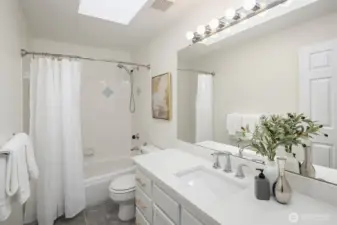 Refreshed hallway bath is shared by the two secondary bedrooms.