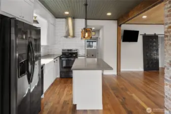 As you enter you see the updated high end finishes and original hardwood floors & brick and mortar.