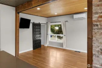 Kitchen island is nicely center to be included in the main floor dining room and living room. The original hardwood floors, large windows and custom barn door, give so much charm to this area.