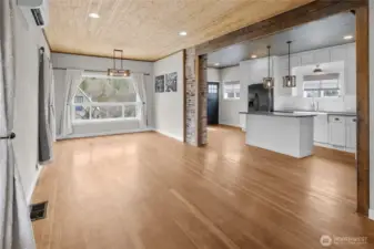 View from barn door to living area, dining room, kitchen and front entry. The space has so much endearing Roslyn charm.