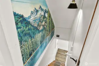 On main floor hallway is your stairs that take you to 2 more bedrooms and a bath on the lower floor. This beautiful custom painting brings the beauty of the outdoors inside.