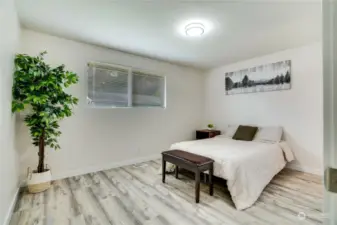 The primary bedroom faces the backyard for extra privacy and peace. Luxury flooring, newer paint and trim, and a great ensuite half bath complete this quiet space.