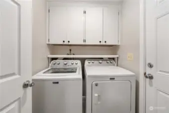 The laundry room has added storage AND the light auto-turns on when you enter the room for hands-free lighting.