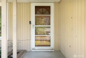 Storm door with built in screen