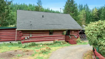 Inside, a circular ornate staircase links the main level bedroom, full bath, and living space with a loft above. Built from Alaska’s toughest tamarack wood, the cabin combines rustic strength with timeless charm, enhanced by a new roof and chimney.