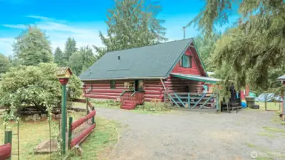 On a quarter-acre cul-de-sac lot in River N Forest, you’ll find multiple outbuildings—including a children’s cabin, saloon-style shed, storage, and wood shed—plus room to grow vegetables in a peaceful, private setting.