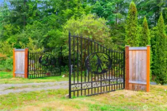 Custom wrought-iron gates with Bigfoot cutouts mark the entrance to the property, blending local legend with rustic artistry and welcoming visitors into this one-of-a-kind home.