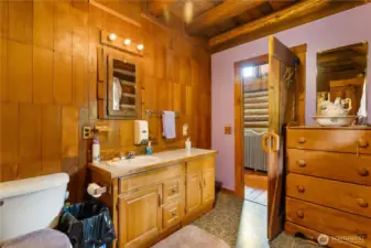 From the log beams overhead to the handmade-style cabinetry, this bathroom feels true to the spirit of the cabin. With natural wood tones and updated lighting, it’s a space that blends old-world charm with everyday comfort.