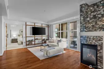 Simply stunning! Rich hardwoods, a striking feature fireplace wall, and abundant natural light create a warm and inviting atmosphere.