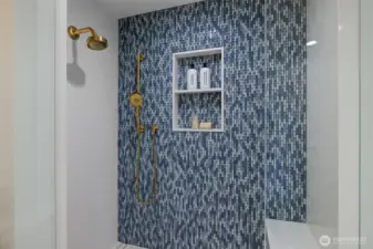 Step into luxury with this elegant tile shower featuring sleek modern fixtures.