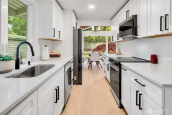 Modern Galley Kitchen, A bright and efficient kitchen with sleek shaker cabinets, quartz counters, and matte black finishes—designed for both form and function.