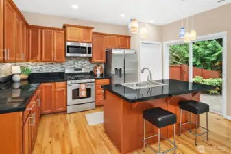Kitchen with center island, stainless appliances, plenty of cabinet storage and pantry.