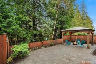 Very scenic and private fenced back yard featuring low maintenance paver patio and gazebo.