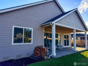 Covered patio overlooking the private, fenced backyard.
