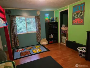 bedroom 2 with walk in closet and view of trees