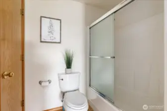 Shower and tub in hallway bathroom.