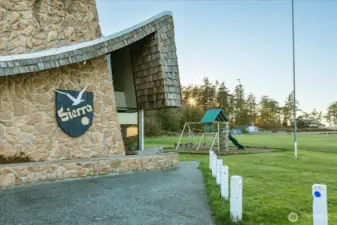 Sierra Club House with play structure beside it. This space can be rented for members parties!