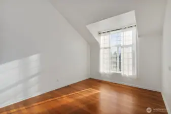 Spacious front living space with large bay windows to allow natural light to bathe the space