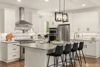 Large kitchen island and full height tile backsplash