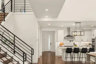 Stairway to second floor, entrance and kitchen area