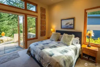 Second en suite bedroom on main floor with private patio.